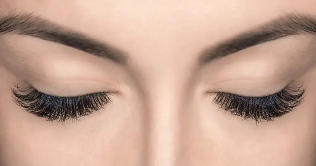 Close up of closed eyes with thick lashes and defined brows after LATISSE eyelash treatment in Gilbert AZ 1