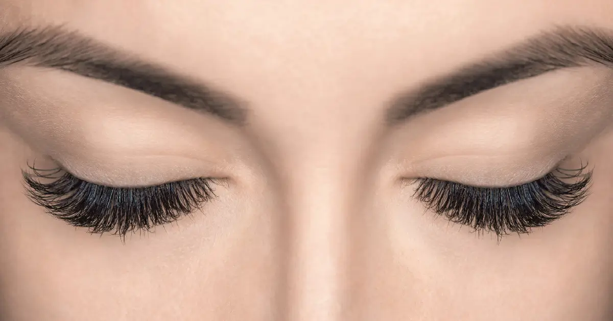 Close-up of closed eyes with thick lashes and defined brows after LATISSE eyelash treatment in Gilbert, AZ.